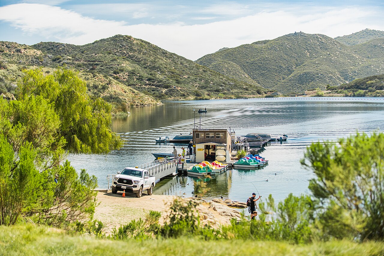 Boats gathered at a dock on Dixon Lake, surrounded by green hills.