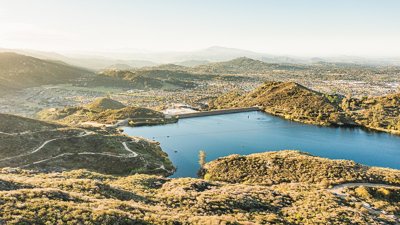 Aerial view of Dixon Lake at sunrise with hills surrounding the water.