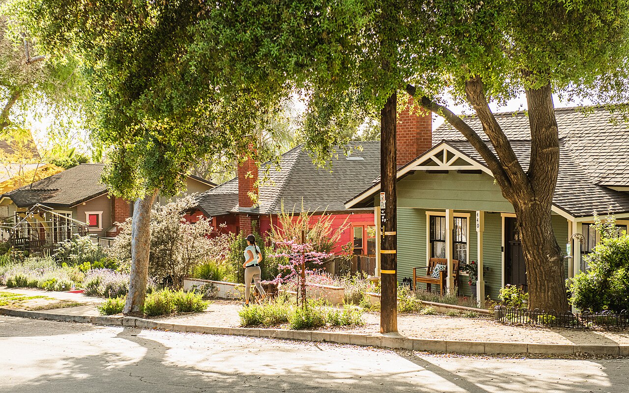 Colorful historic houses beneath mature trees in an Old Escondido neighborhood.