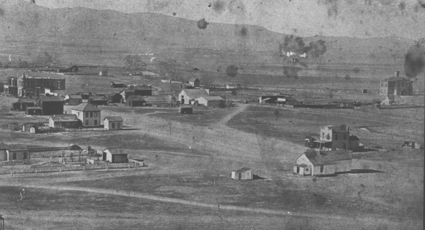 An early Escondido neighborhood of scattered houses and open lots beneath low hills.